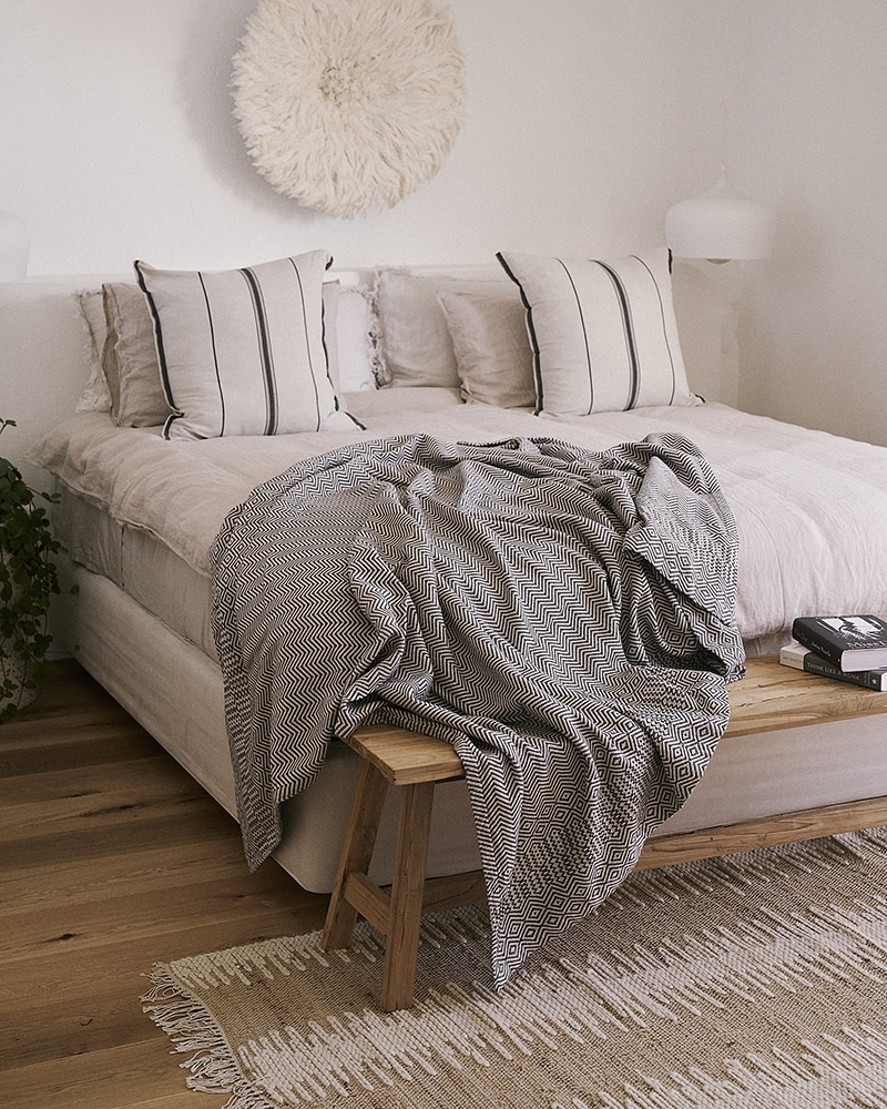 Mungo Bakuba Throw on a bed. 100% cotton blankets and throws, woven at the Mungo Mill.