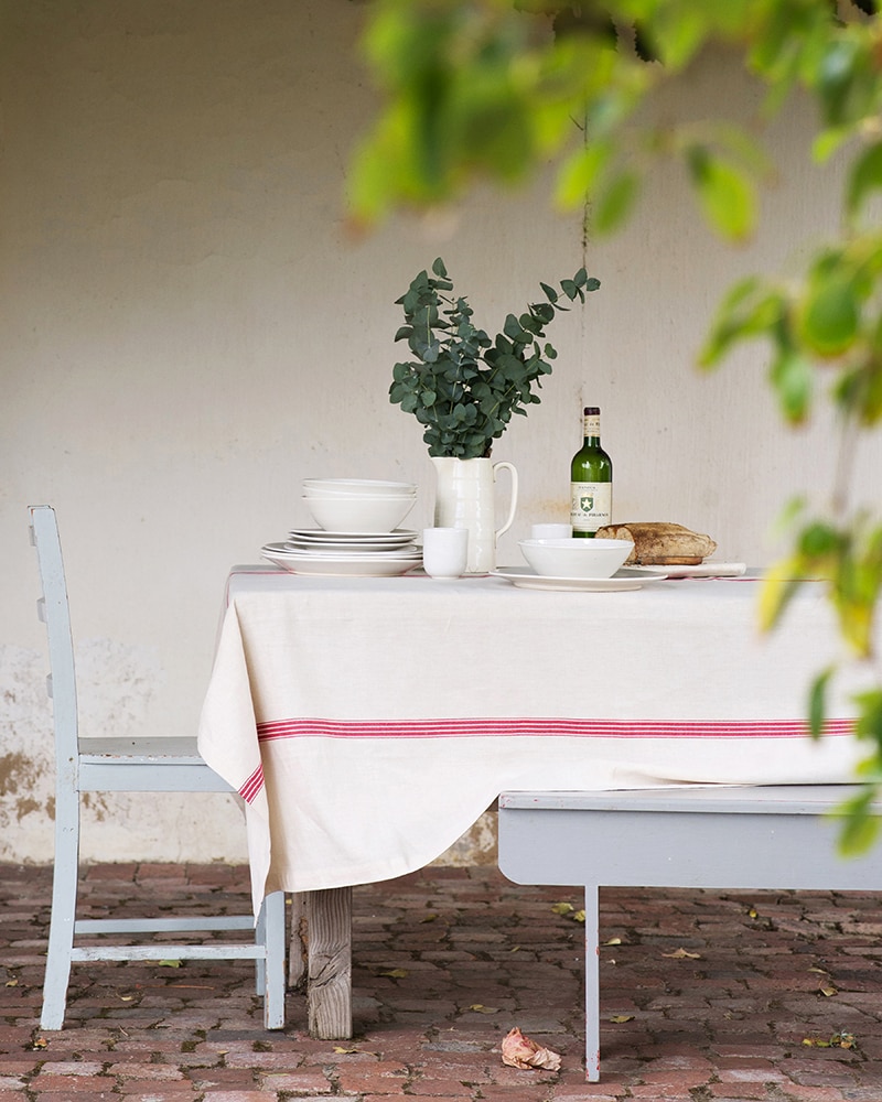 El fresco country table set with a Mungo Linen Provincial Stripe Table Cloth in Red.