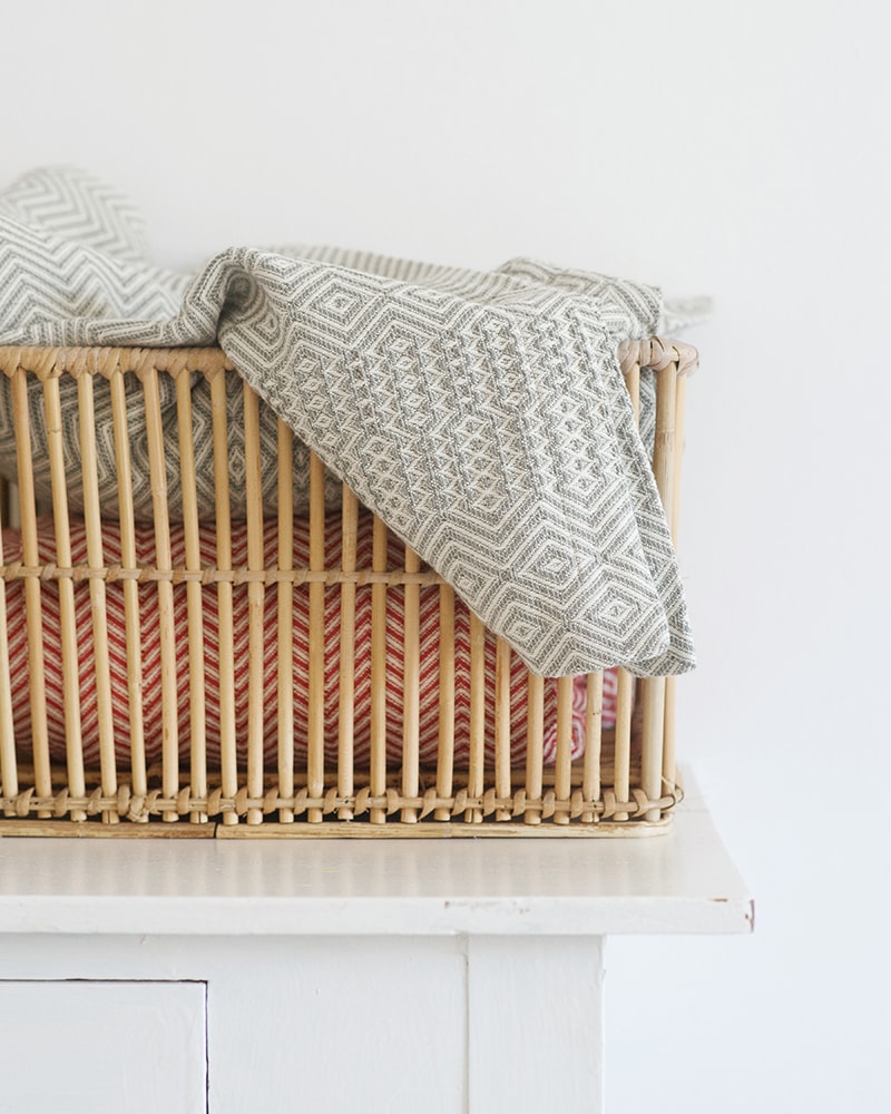 Mungo Cotton Bakuba Throws in Red and Smoke, woven with all natural fibres at our mill in Plettenberg Bay, South Africa.