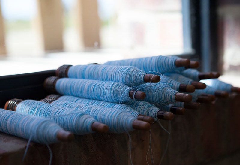 A stack of pirns ready to be woven into the Mungo summer towel on our Lancashire looms