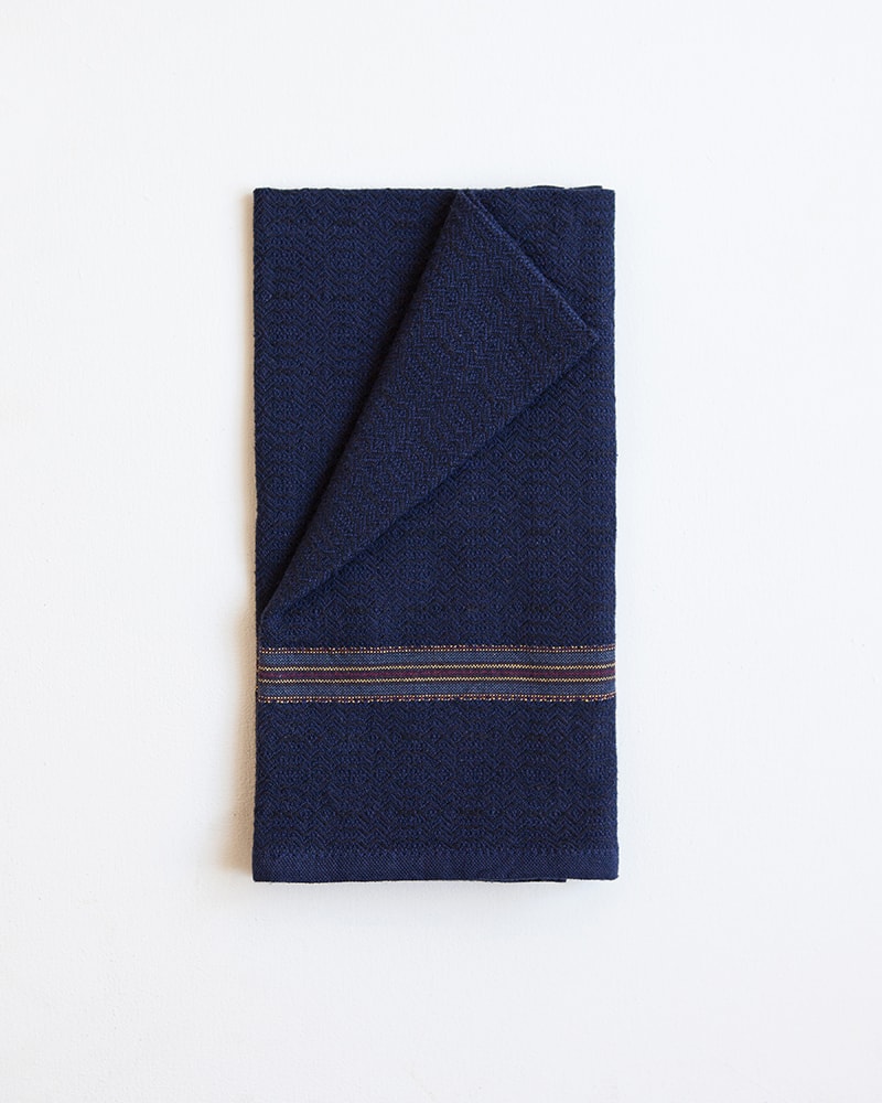 The intricately patterned Boma Napkin in Black Indigo is woven at the Mungo Mill in Plettenberg Bay