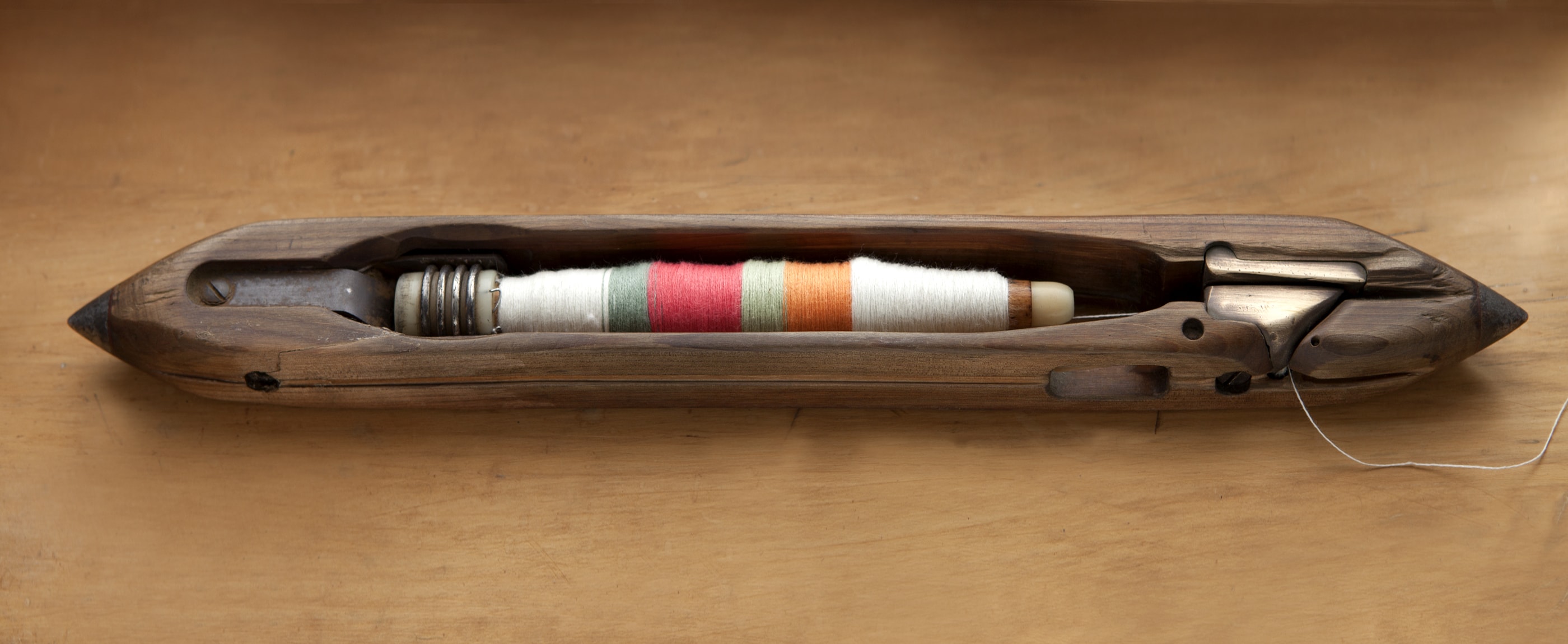 Mungo a wooden pirn for use in an antique loom