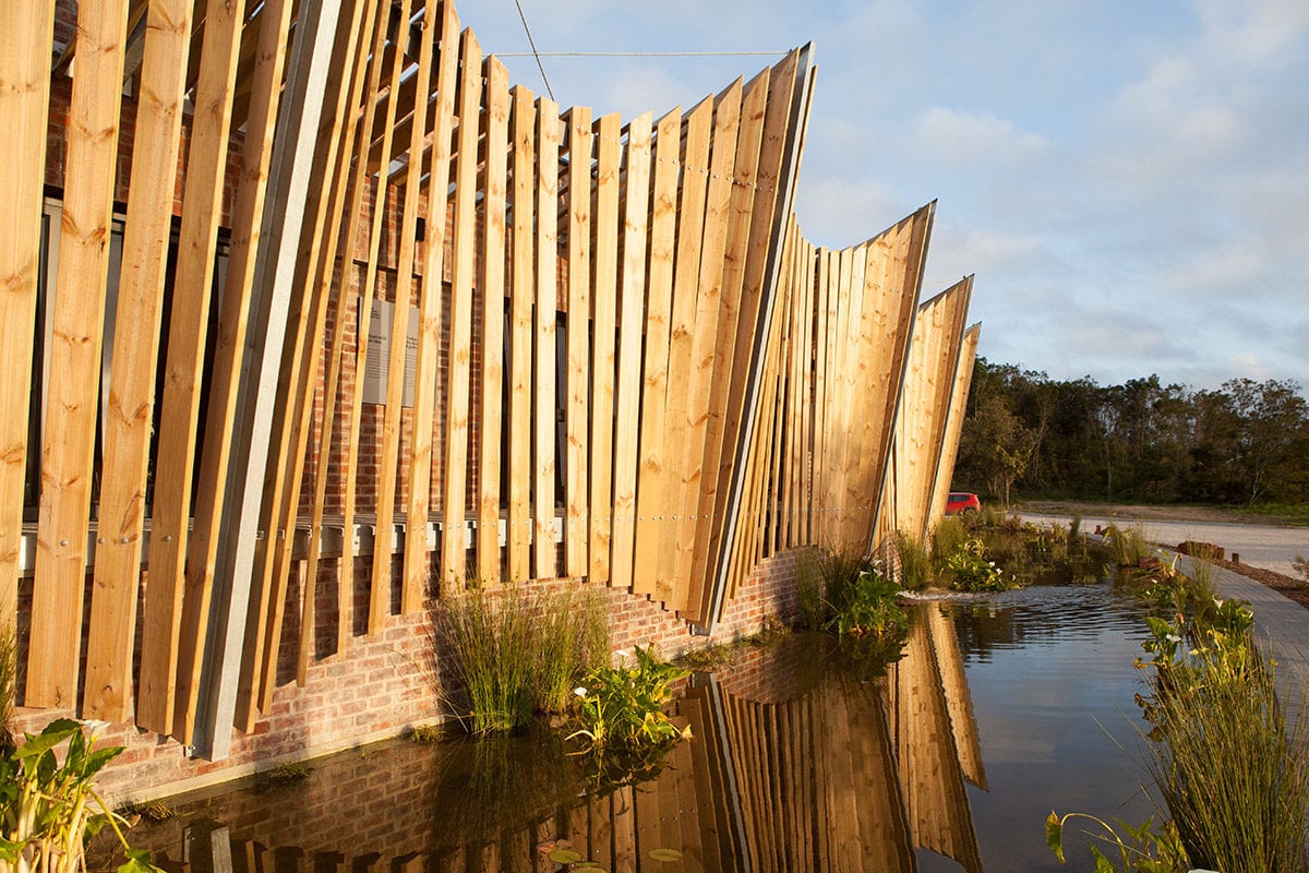 The exterior skin of the Mungo mill in Plettenberg Bay reflected in the mill pond.