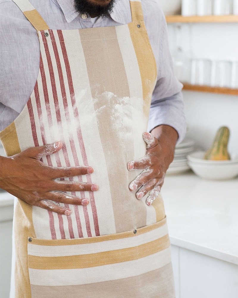 The Mungo Chef's Apron in Yam in a kitchen scene.