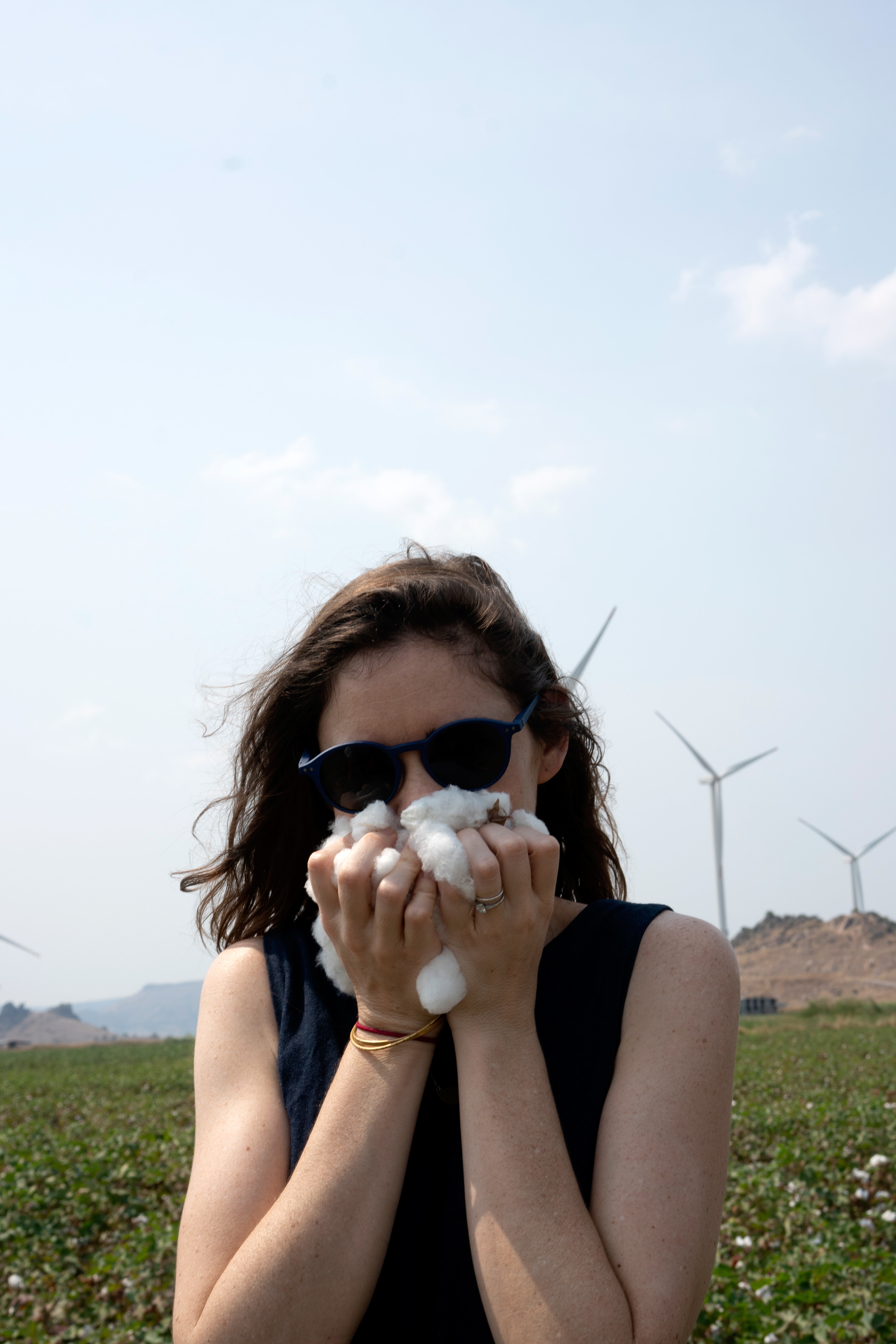 Tessa sniffs a handful of organic cotton in Turkey