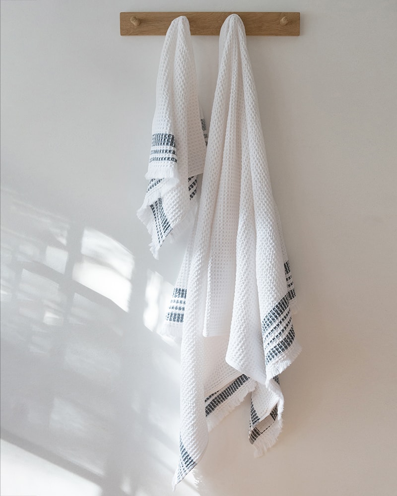 Mungo Organic Belgian Waffle Towels hanging in a bathroom