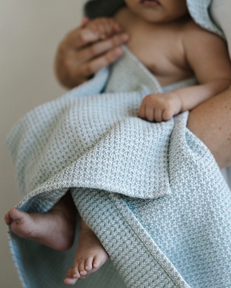 Baby wrapped up in a Mungo Organic Hooded Baby Towel