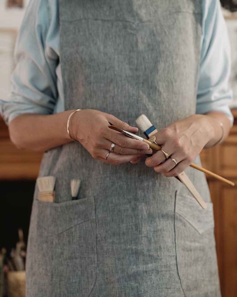 In the studio with illustration Katrin Coetzer, wearing the Mungo Artists Apron. 100% linen workwear aprons