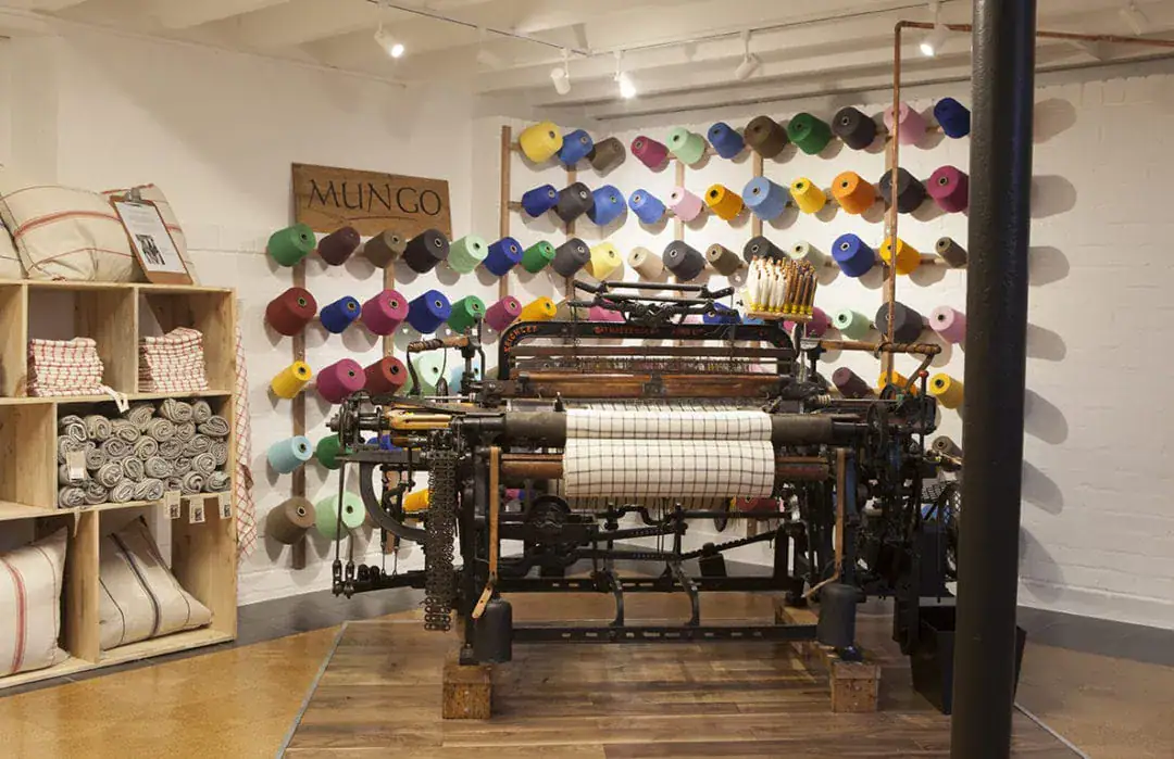 Inside the Mungo micro-mill on 78 Hout Street. View of a Cook's Cloth on a Hattersley loom