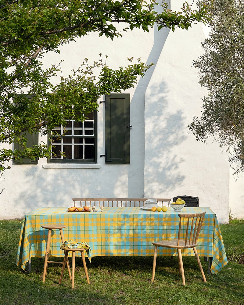 Garden alfresco scene with a Mungo Caribbean Check tablecloth. Natural fibre woven textiles made in South Africa