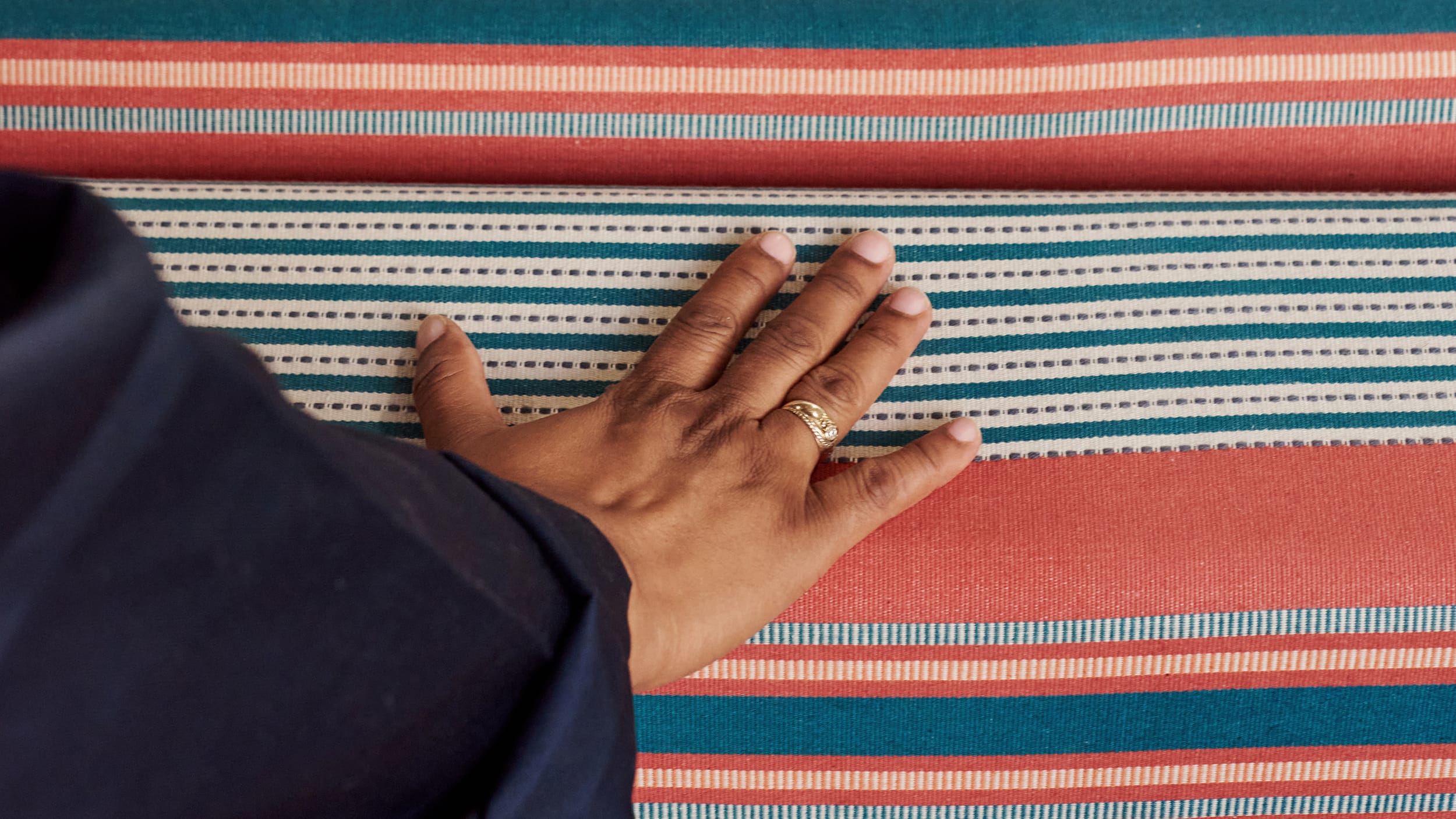 Hands on a loom inside the Mungo Mill - a banner for a blog on fast