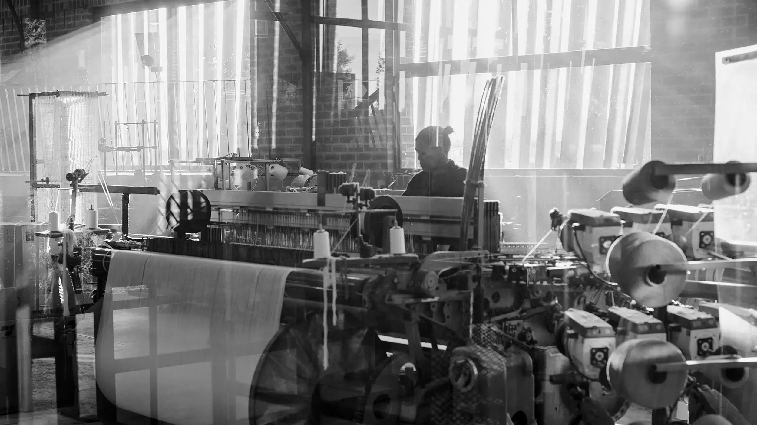Weaver at the loom inside the Mungo mill