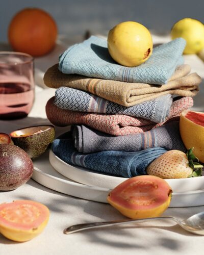 A stack of 100% cotton boma cloths on a festive table