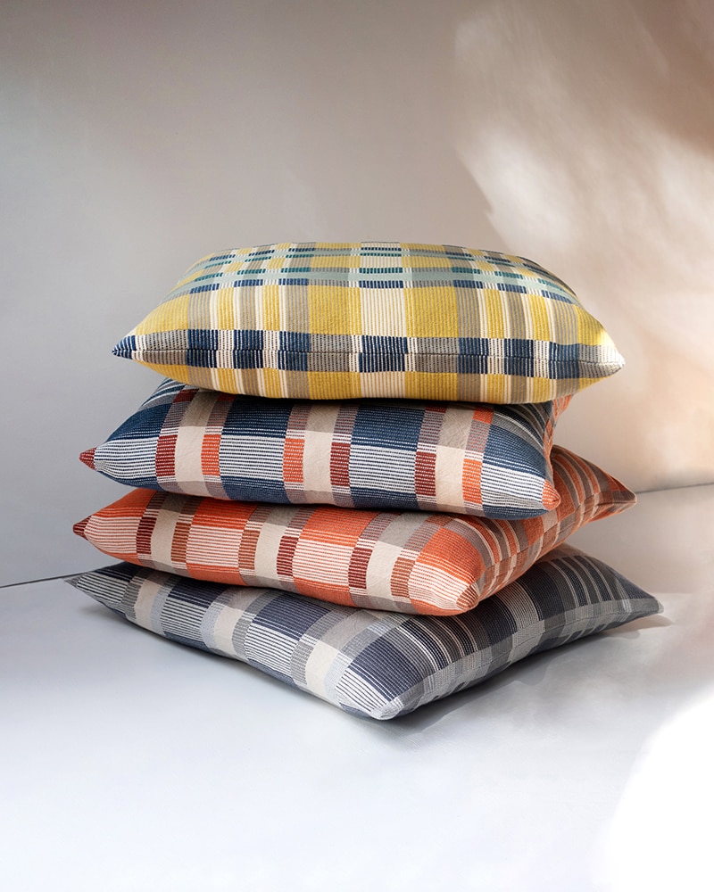 A stack of the Mungo Skipping Block Cushions