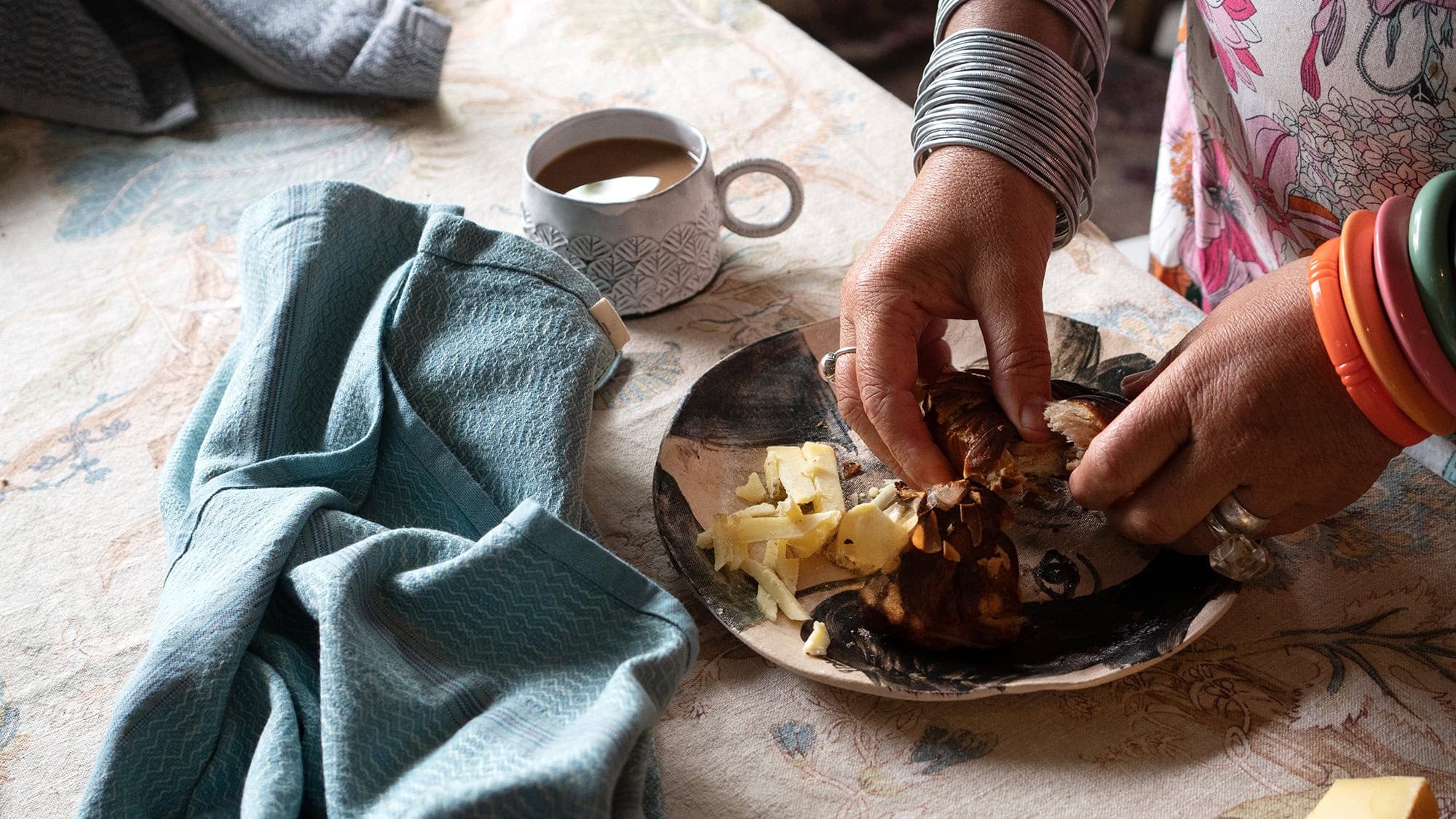 Karen Dudley, chef, food writer and podcast host, styling a plate of food in her home kitchen.