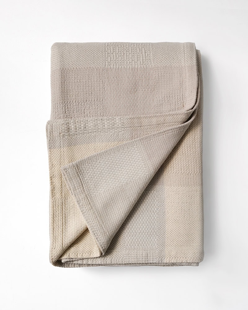 Product image of the folded linen and cotton Savannah Blanket in Grasslands