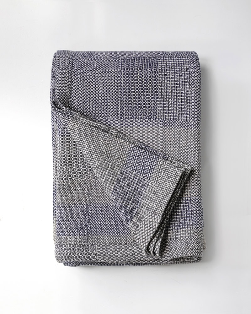 Product image of the folded linen and cotton Savannah Blanket in Monsoon.
