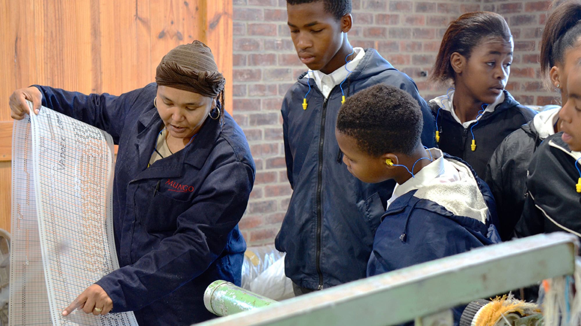 Showing students punch cards for weaving