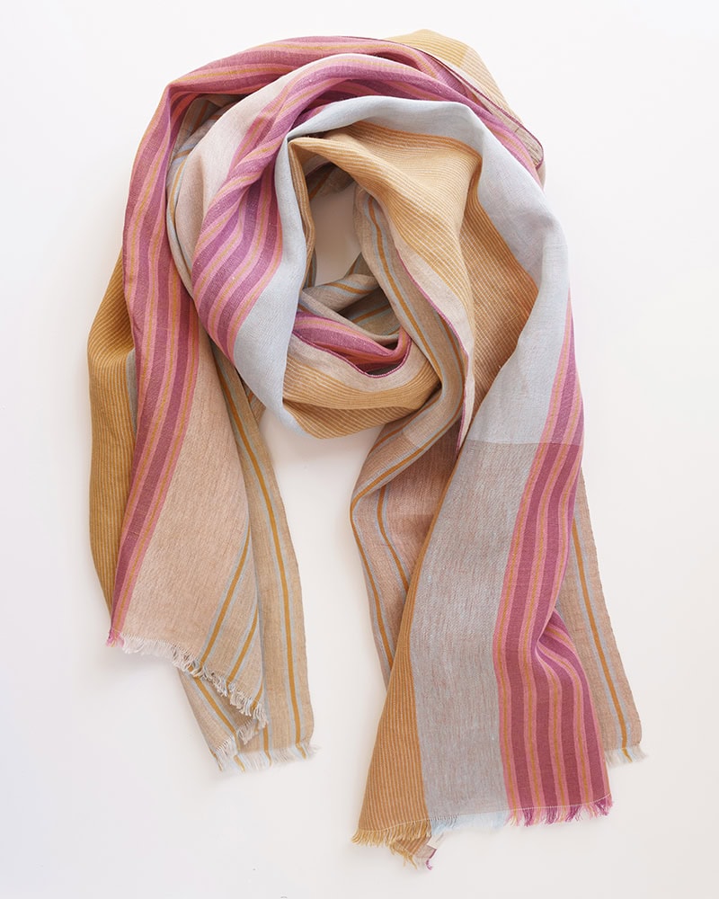 Product view of the Mungo Macaron linen scarf on white background, highlighting its woven texture and colourful candy-stripe design in pink, cream, gold, and sky blue.