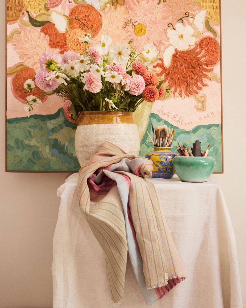 The Mungo Linen Scarf in front of a floral arrangement serving as inspiration for Lene Ehlers painting