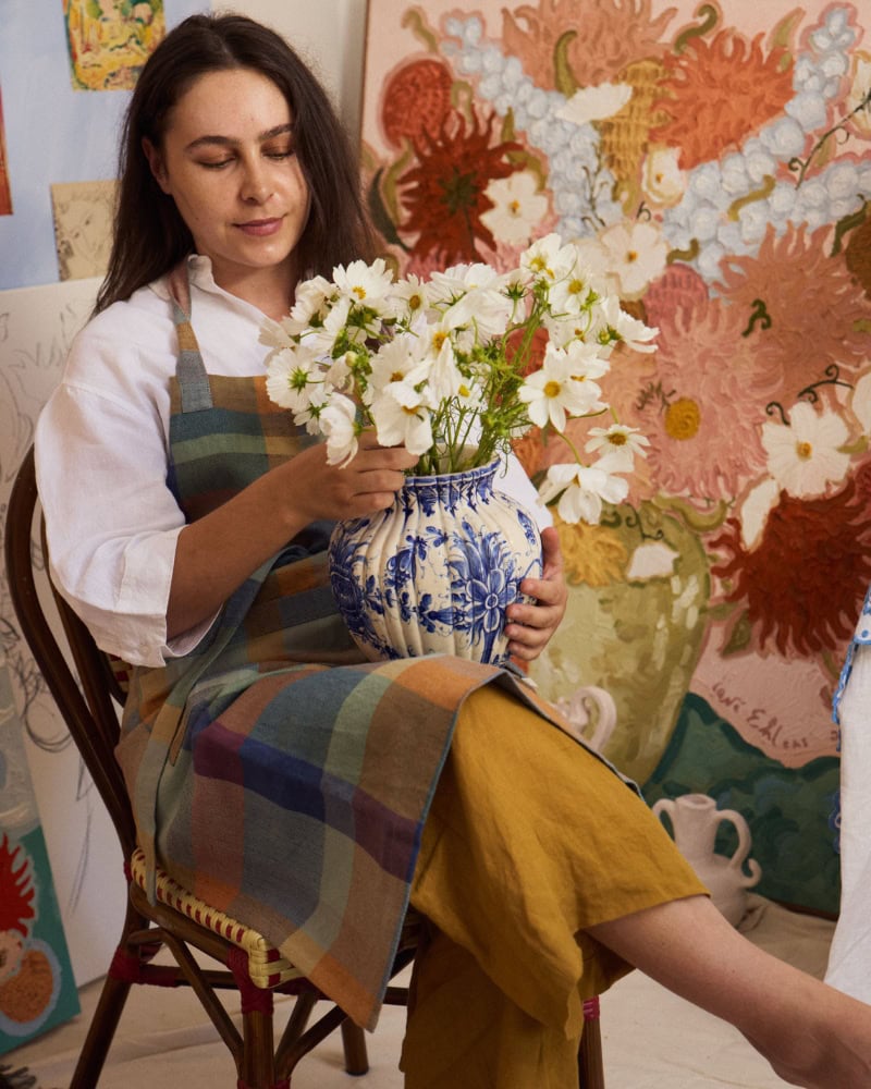 Lene Ehlers, oil artist, holding a bouquet of white flowers